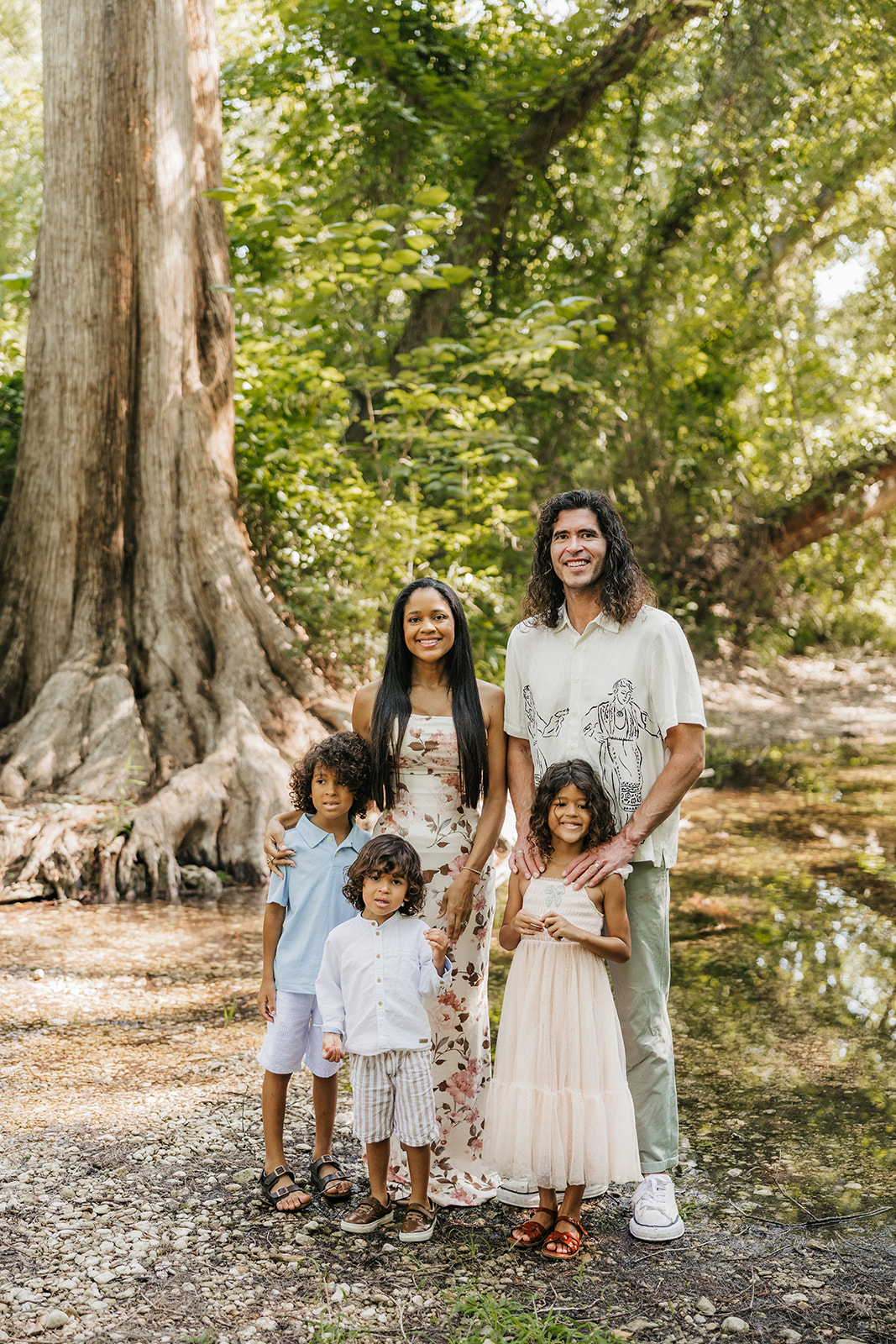 The Santucci family together by a woodland creek
